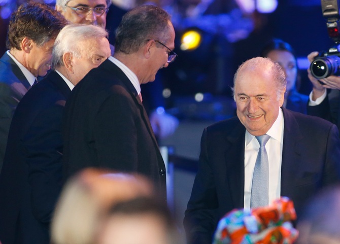 FIFA President Joseph Blatter,right, arrives at the opening ceremony of the 64th FIFA Congress