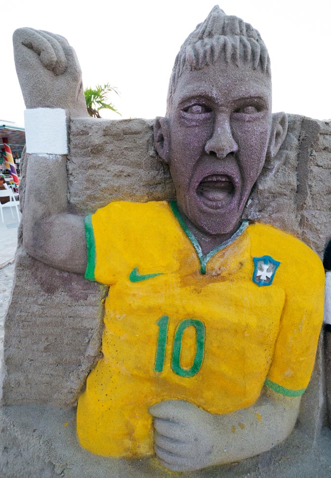 A sandcastle model of Neymar on the Copacabana Beach in Rio de Janeiro.