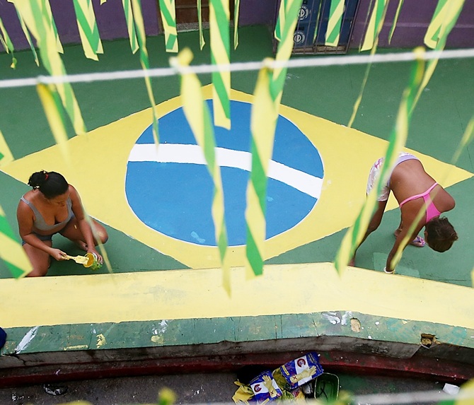 Brazilians paint a section of the Santa Marta shantytown, or 'favela', in Brazilian colors