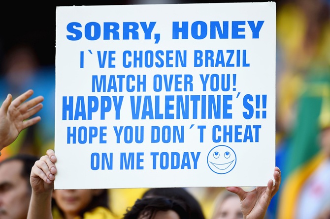 A fan holds up a sign before the Opening Ceremony