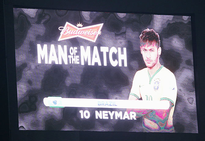 Neymar of Brazil receives the man of the match during the 2014 FIFA World Cup Brazil Group A match between Brazil and Croatia at Arena de Sao Paulo on Thursday