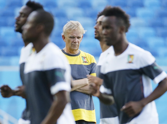 Cameroon's national soccer team head coach Volker Finke,centre, watches his players as they attend a practice session