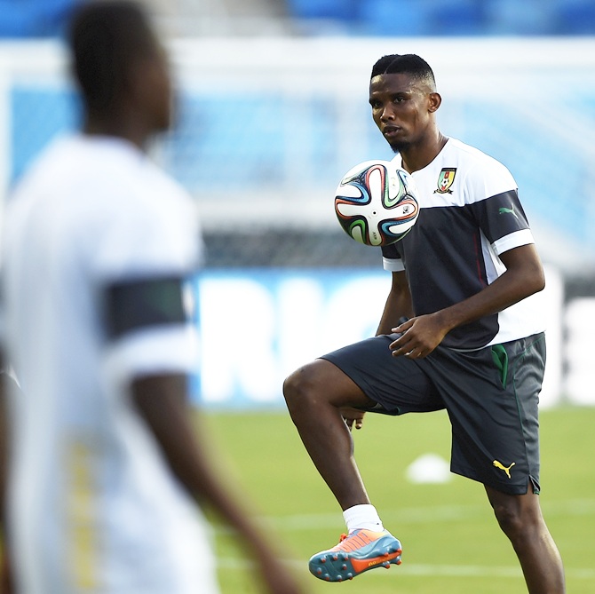 Cameroon's captain Samuel Eto'o,right, controls the ball during a team practice session