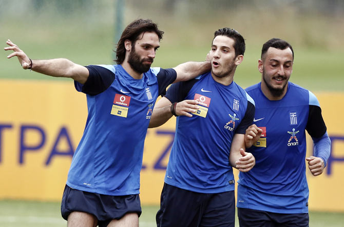 Greece's Kostas Mitroglou (right), Kostas Manolas (centre) and Georgios Samaras attend a training session
