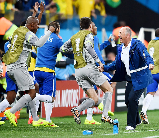Head coach Luiz Felipe Scolari of Brazil (right) celebrates with his team after their win over Croatia on Thursday