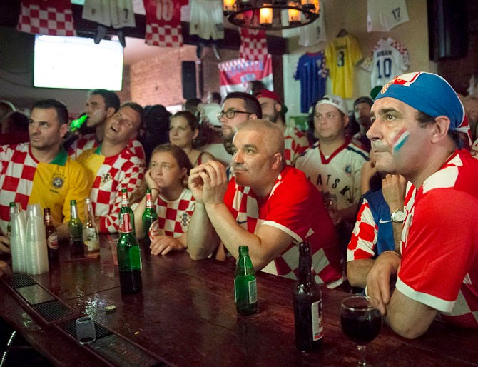 Croatian fans watch the opening match of the football World Cup in a bar on Thursday