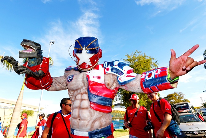 A Chile fan enjoys the atmosphre prior to the 2014 FIFA World Cup match
