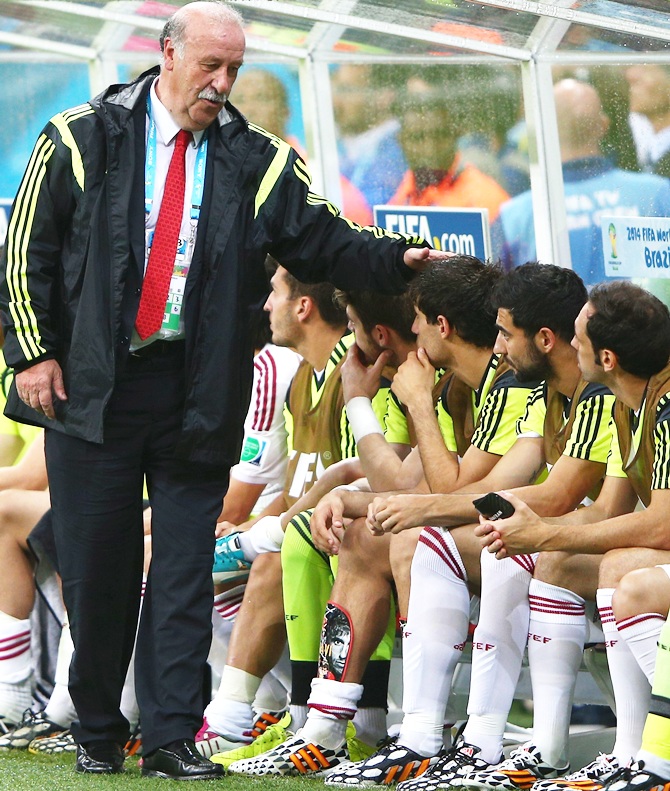 Head coach Vicente del Bosque of Spain speaks to his players on the bench