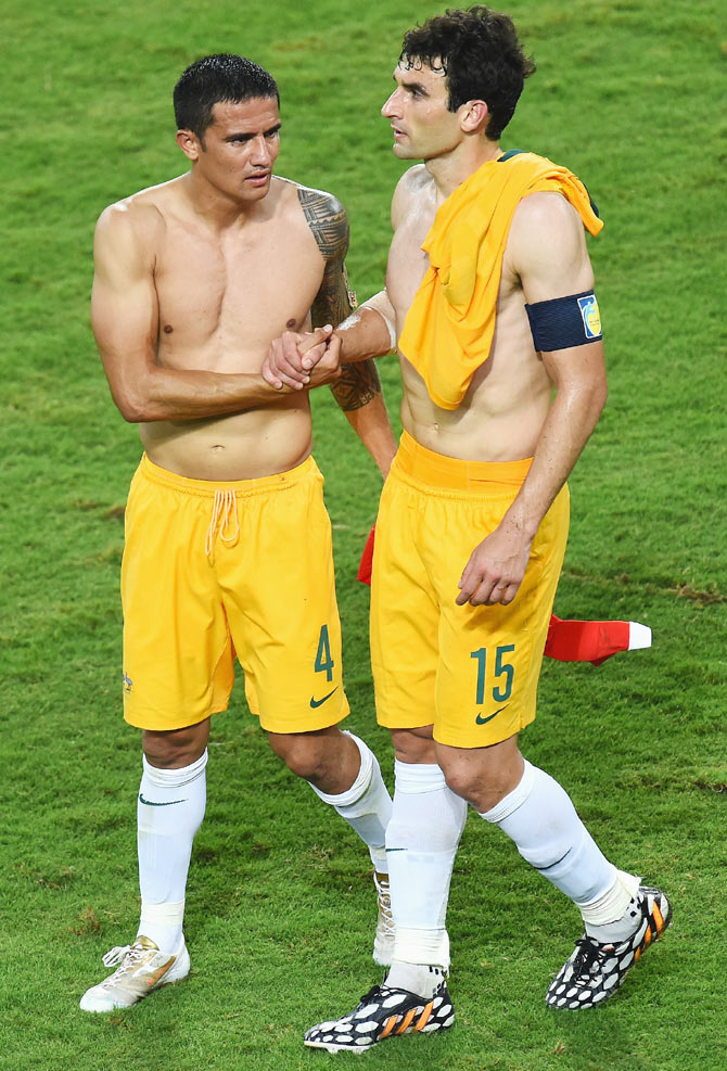 Tim Cahill (left) and Mile Jedinak of Australia shake hands after being defeated by Chile 3-1 on Friday