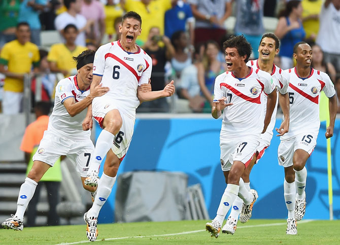 Oscar Duarte of Costa Rica (second left) celebrates scoring his team's second goal against Uruguay with teammates