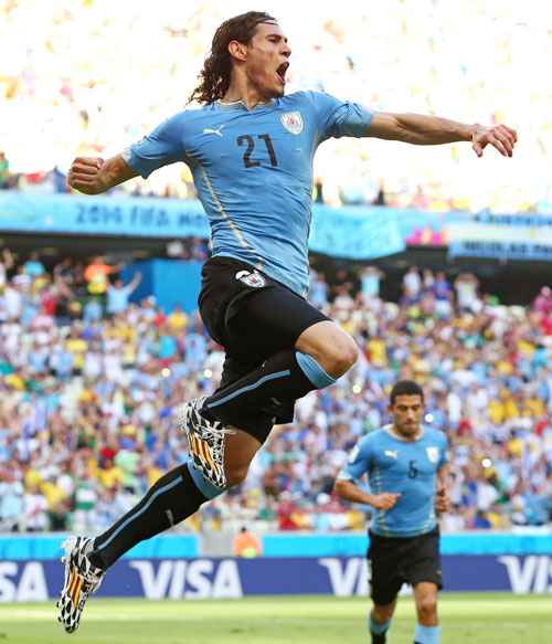 Edinson Cavani of Uruguay celebrates scoring his team's first goal on a penalty kick