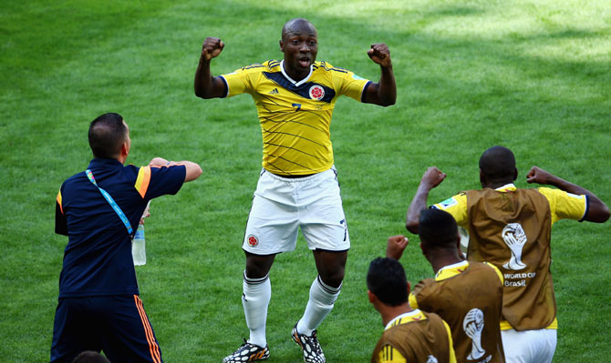 Pablo Armero of Colombia celebrates with his team-mates after scoring the first goal
