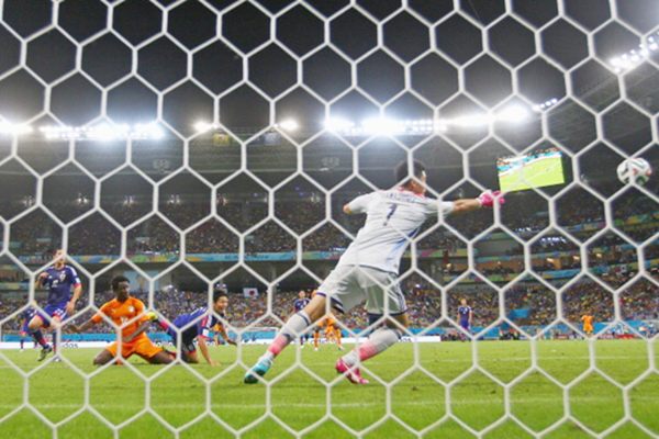 Wilfried Bony of the Ivory Coast scores on a header for his team's first goal past Eiji Kawashima of Japan