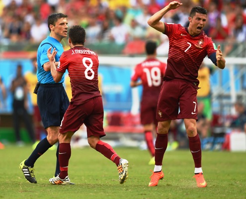 Joao Moutinho (centre) and Cristiano Ronaldo of Portugal (right) appeal to referee Milorad Mazic for a foul