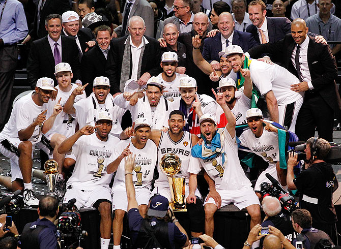 The San Antonio Spurs celebrate with the Larry O'Brien trophy after defeating the Miami Heat to win the 2014 NBA Finals at the AT&T Center in San Antonio, Texas, on Sunday
