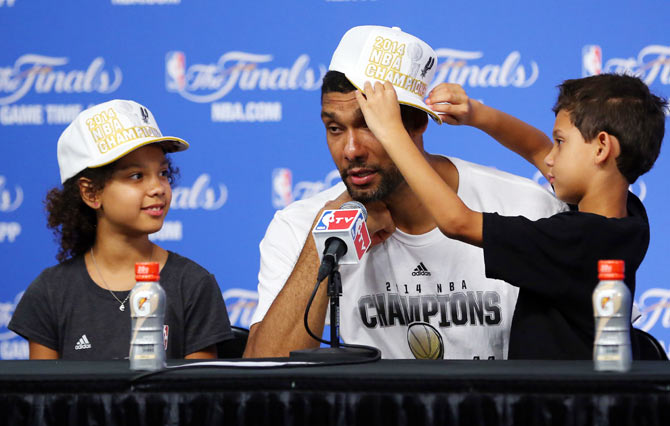 Tim Duncan of the San Antonio Spurs speaks to the media with his children Sydney and Draven after defeating the Miami Heat in Game Five of the 2014 NBA Finals at the AT&T Center on Sunday