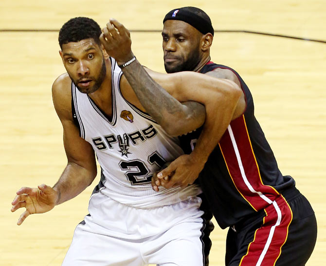 Tim Duncan of the San Antonio Spurs and LeBron James of the Miami Heat in action during Game Five of the 2014 NBA Finals at the AT&T Center on Sunday