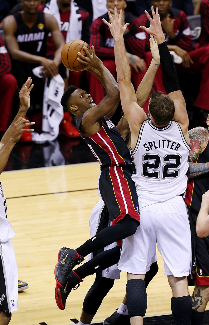 Norris Cole of the Miami Heat goes to the basket against Tiago Splitter of the San Antonio Spurs on Sunday