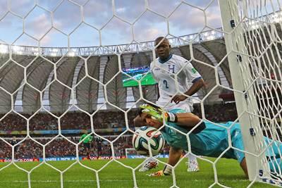 Goalkeeper Noel Valladares of Honduras tries to prevent the ball from crossing the goalline following a shot by France's Karim Benzema.Ka