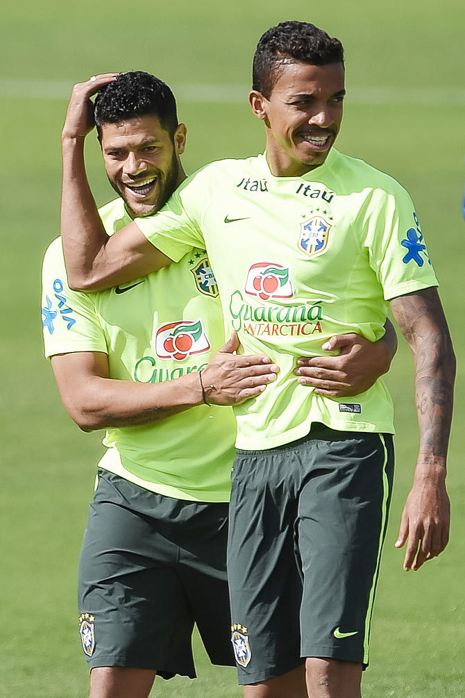 Hulk (left) jokes with Luis Gustavo during a training session of the Brazilian national football team at the squad's Granja Comary training complexin Teresopolis, 90 km from downtown Rio de Janeiro on Saturday