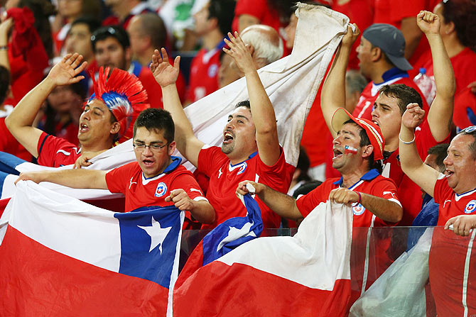 Chile fans cheer during the 2014 FIFA World Cup Brazil Group B match between Chile and Australia at Arena Pantanal in Cuiaba on Friday