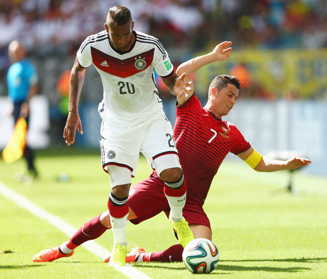 Jerome Boateng of Germany challenges Cristiano Ronaldo of Portugal on Monday