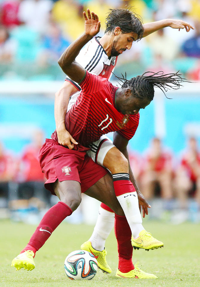 Eder (left) of Portugal battles for the ball with Sami Khedira of Germany on Monday