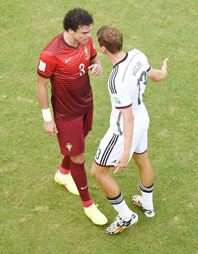 Thomas Mueller of Germany reacts after a headbutt by Pepe of Portugal resulting in the latter receiving a red card on Monday