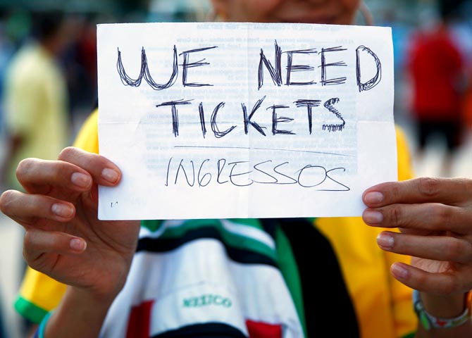 A fan holds a 'We Need Tickets' sign prior to the 2014 FIFA World Cup Brazil Group F match between Argentina and Bosnia-Herzegovina at Maracana in Rio de Janeiro
