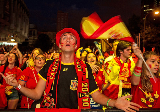 A Spanish soccer fan watches as his team plays against the Netherlands
