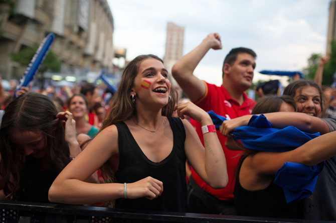 A Spanish soccer fan celebrates while watching Spain score a goal against the Netherlands