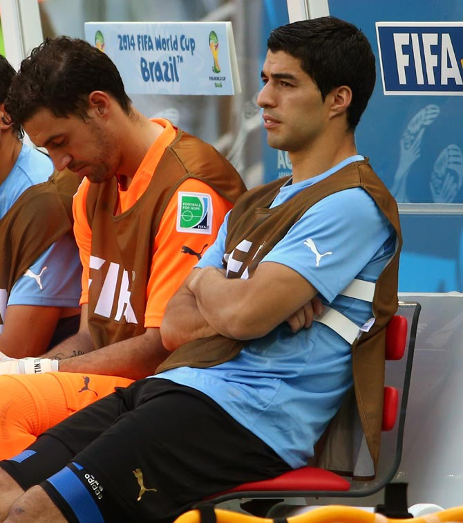 Luis Suarez (right) sits on the bench