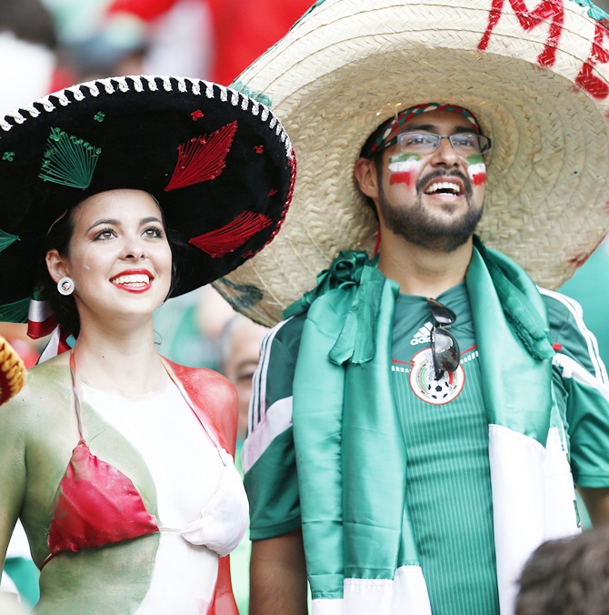Fans of Mexico wait for the start of their 2014 World Cup Group A soccer match against Brazil at the Castelao arena in Fortaleza