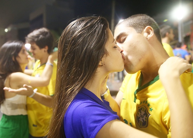 Brazil fans kiss after watching the Brazil-Mexico match