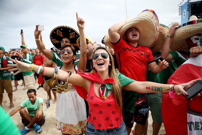 Mexican soccer team fans react to their team winning the match against Cameroon