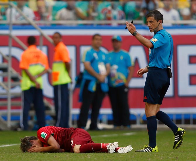 Fabio Coentrao of Portugal lies on the field after an injury