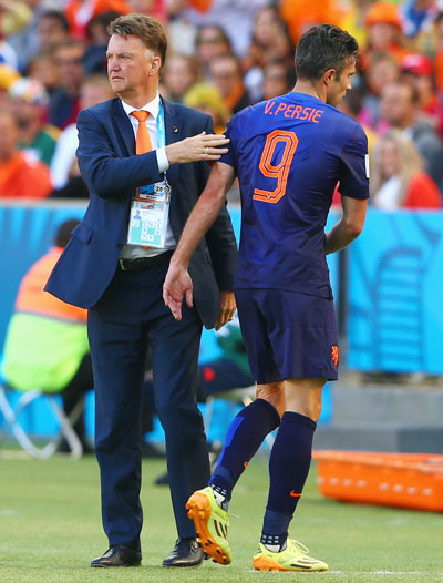 Robin van Persie of the Netherlands reacts with head coach Louis van Gaal as he exits the game