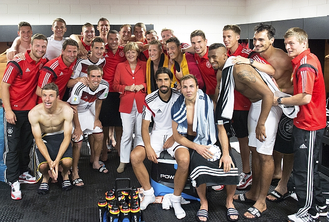 German chancellor Angela Merkel visits the dressing room after the game against Portugal