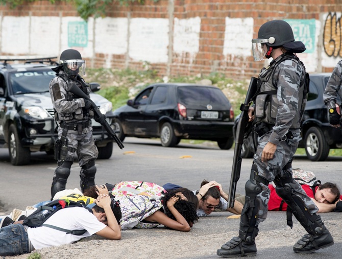 Riot police detain protesters during a demonstration against the 2014 World Cup in Fortaleza