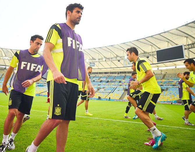 Spain players warm up during a training session