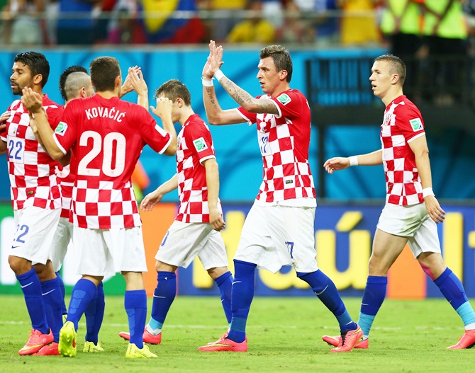Mario Mandzukic of Croatia, second right, celebrates scoring his team's fourth goal, his second, during the 2014 FIFA World Cup against Cameroon