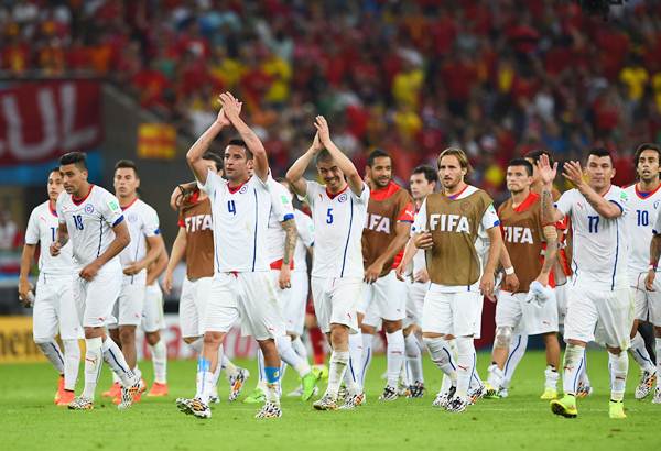 Mauricio Isla of Chile and his teammates ackonowledge applause from the fans after beating defending champions Spain a 2-0 in the Group B World Cup match.