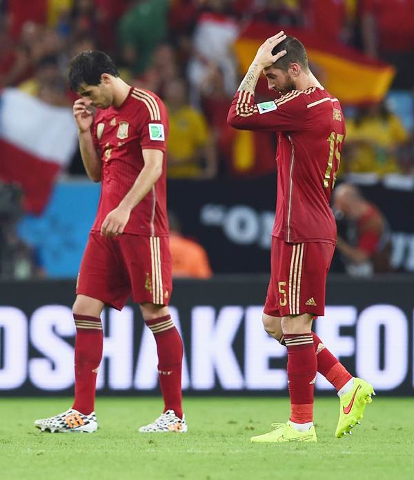 Spain's Javi Martinez and Sergio Ramos walk off the field after the defeat to Chile