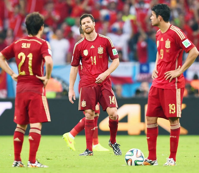 Xabi Alonso of Spain looks on with teammates