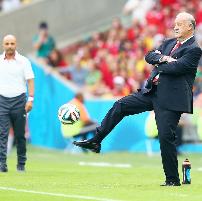 Head coach Vicente del Bosque of Spain kicks the ball on the sideline