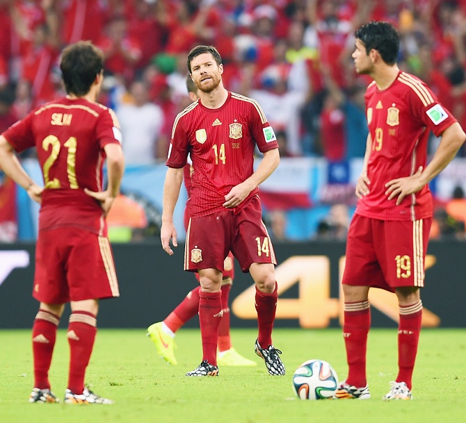 Xabi Alonso of Spain looks on as his teammates wait to kickoff