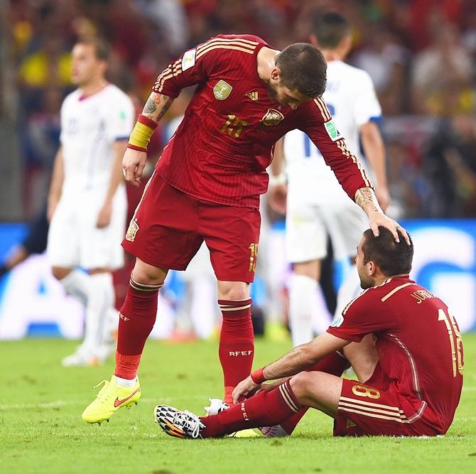 Sergio Ramos of Spain consoles Jordi Alba after the 2-0 defeat to Chile in the 2014 FIFA World Cup Brazil Group B match