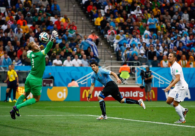 Luis Suarez of Uruguay scores his team's first goal past England goalkeeper Joe Hart