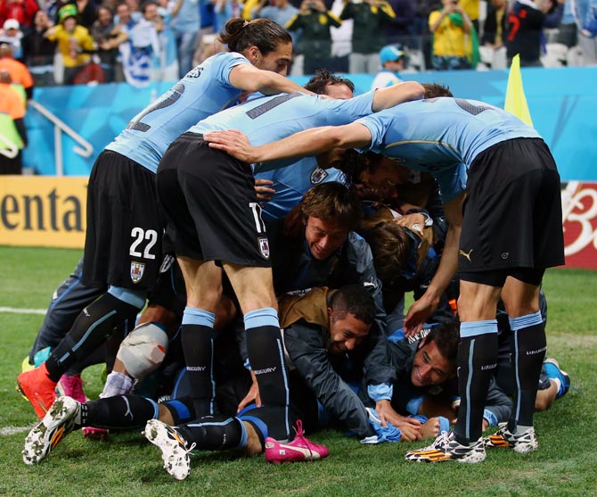 Uruguay's players celebrate after Luis Suarez scored the second goal.