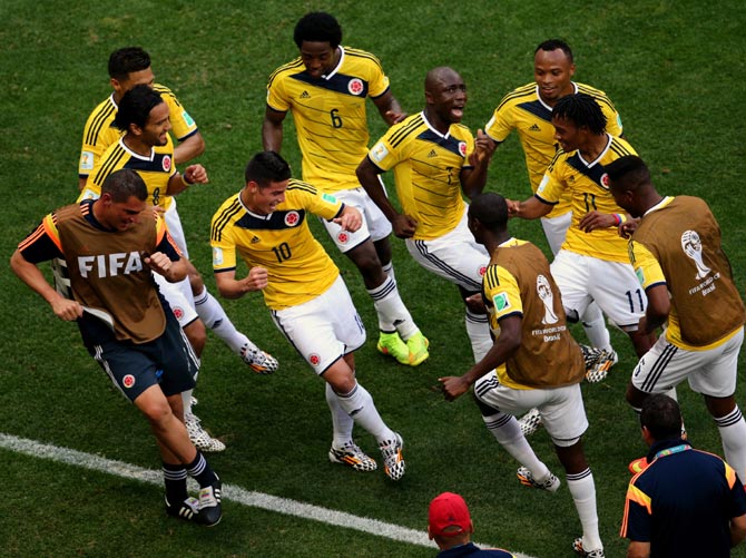 Colombia's players celebrate after James Rodriguez (No.10) scored the opening goal against Ivory Coast.